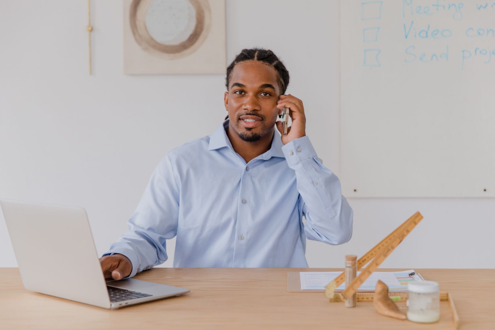 Business owner smiling while replying to a customer on a phone