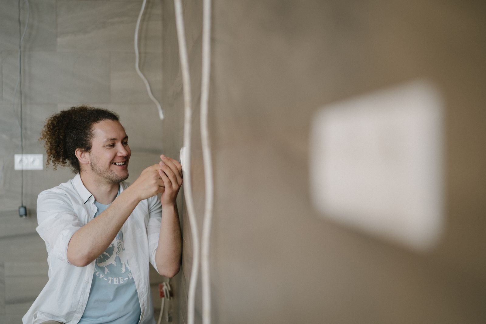 Electrician working on wiring with hand tools