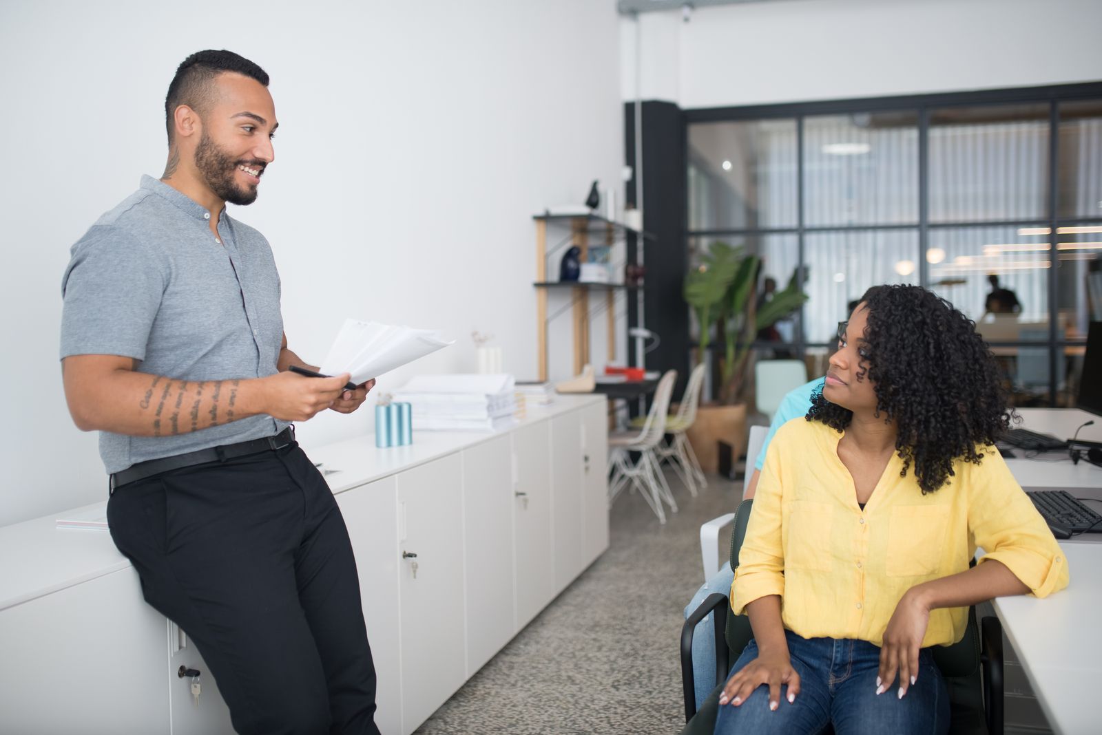 Two team members in a friendly discussion at work